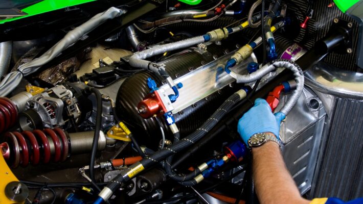 mechanic working on racing car engine