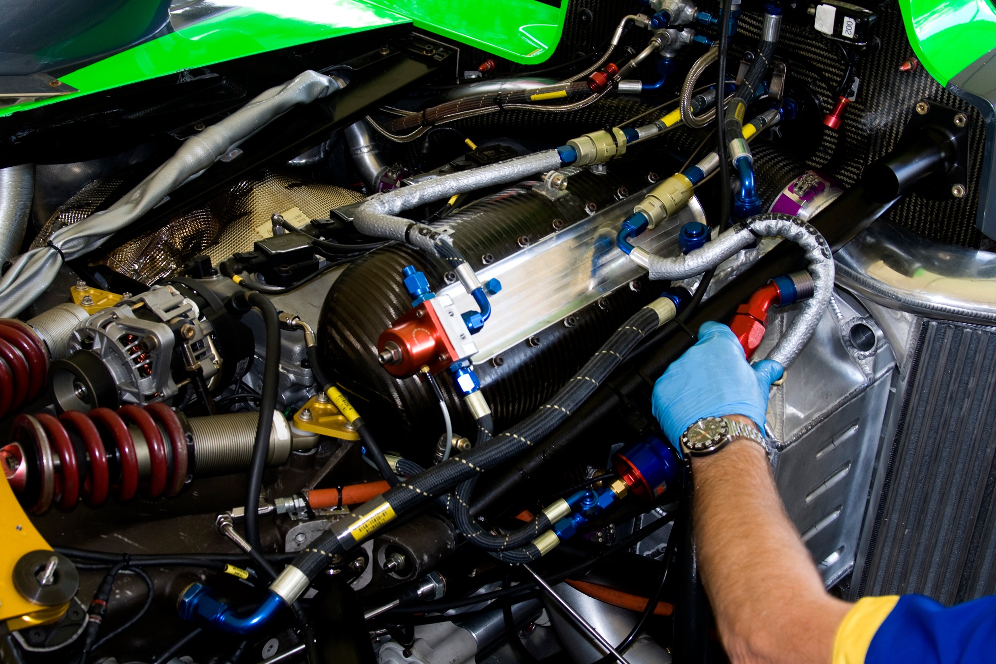 mechanic working on racing car engine